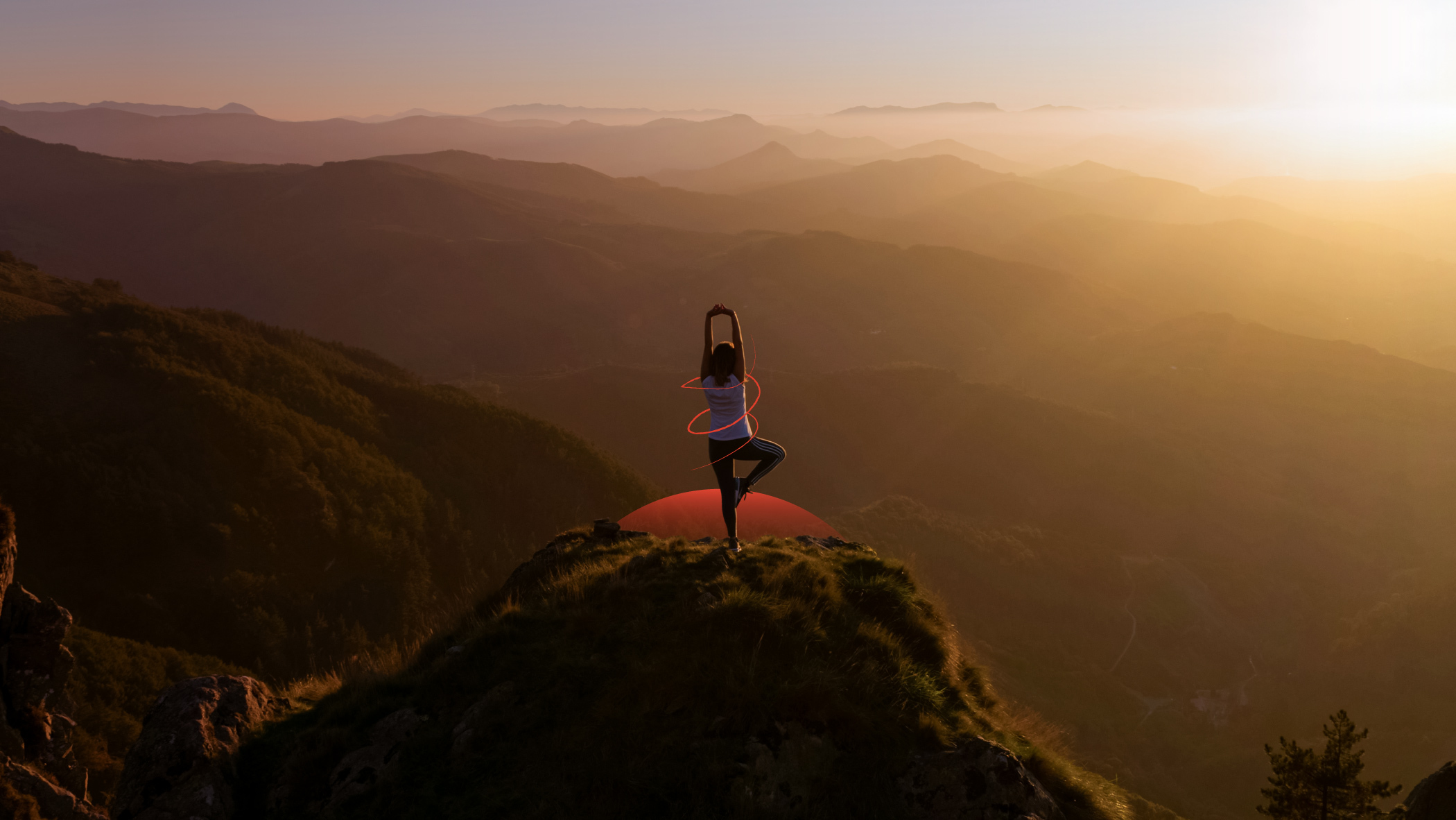 A woman is practicing yoga at the top of the hill